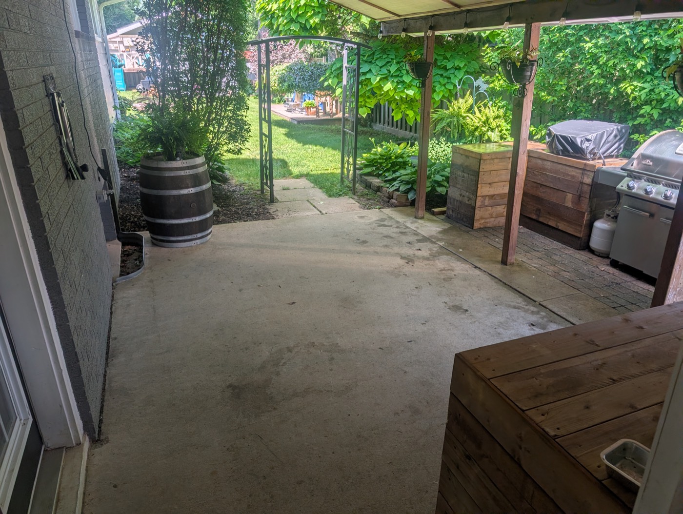 Concrete patio before pressure washing, covered in dirt and stains